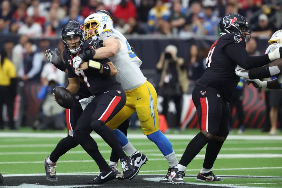 Jan 11, 2025; Houston, Texas, USA; Los Angeles Chargers outside linebacker Joey Bosa (97) sacks Houston Texans quarterback C.J. Stroud (7) during the first quarter in an AFC wild card game at NRG Stadium. Mandatory Credit: Troy Taormina-Imagn Images