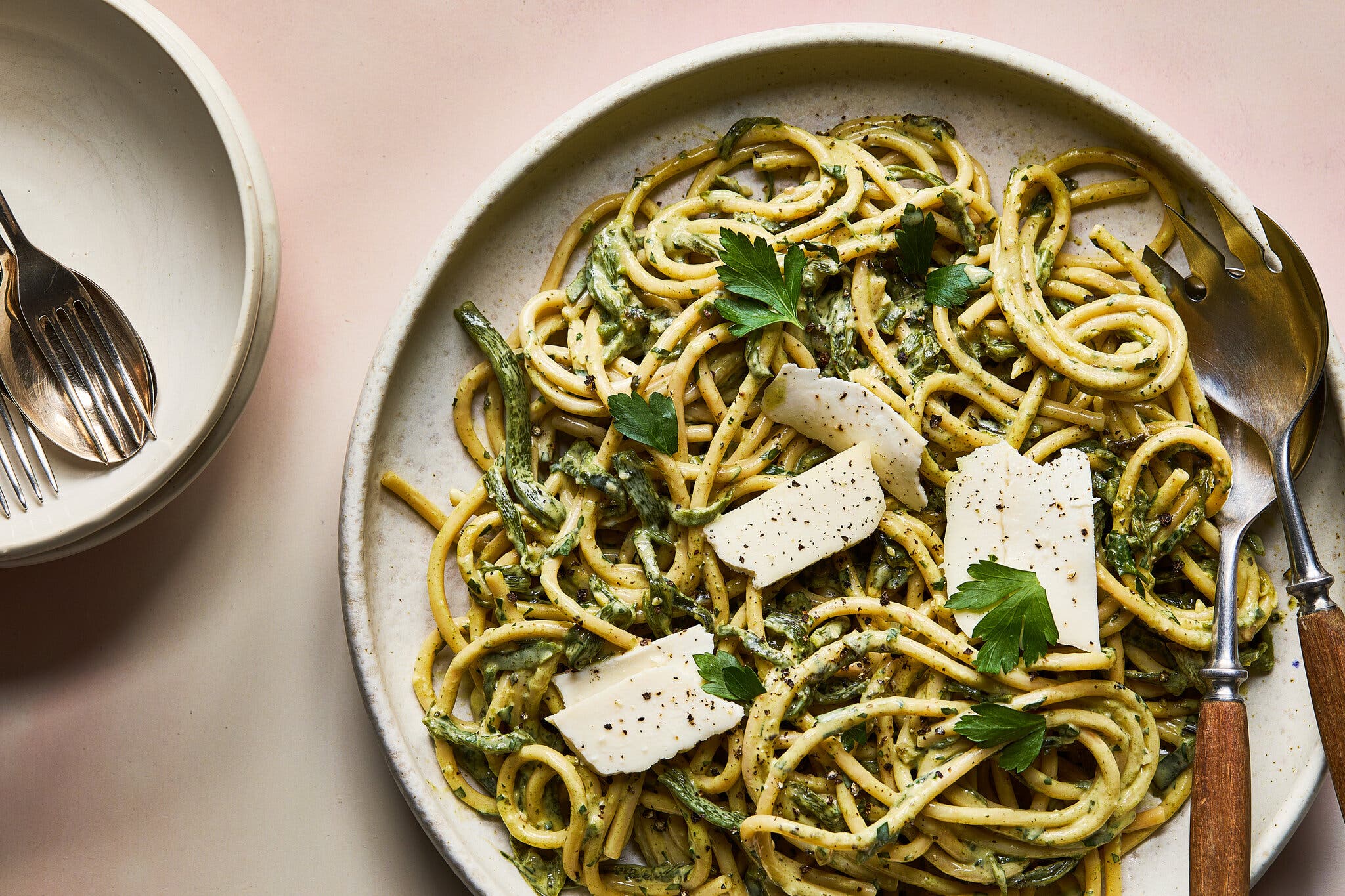 An overhead image of a creamy pasta coated in a poblano-based sauce and topped with herbs and cheese.