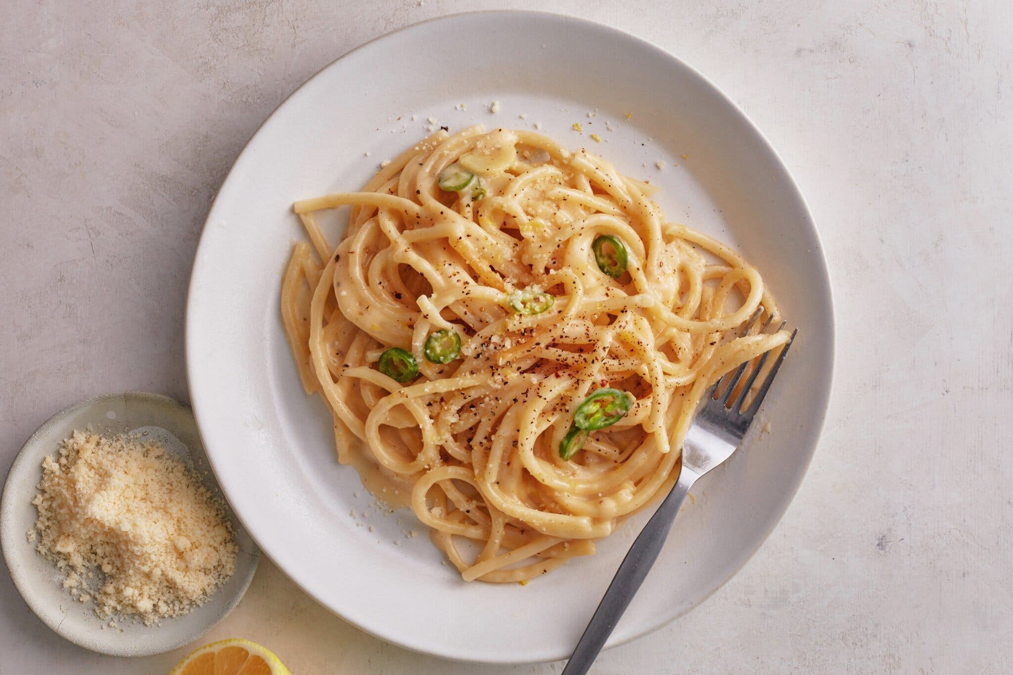 A creamy noodle pasta on a white plate.