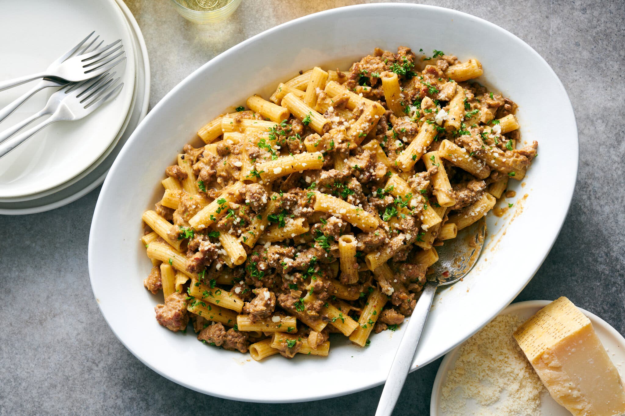 A creamy, meaty pasta on a white platter.