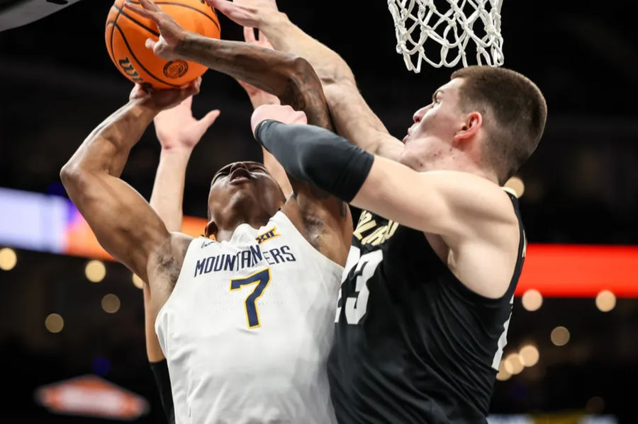 Mar 12, 2025; Kansas City, MO, USA; West Virginia Mountaineers guard Javon Small (7) and Colorado Buffaloes forward Andrej Jakimovski (23) collide under the basket during the first half at T-Mobile Center. Mandatory Credit: William Purnell-Imagn Images