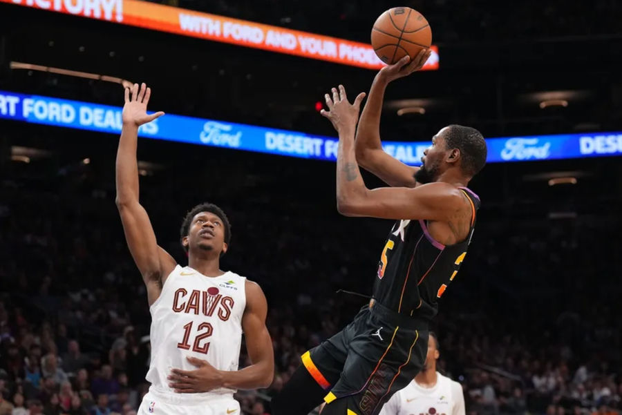 Mar 21, 2025; Phoenix, Arizona, USA; Phoenix Suns forward Kevin Durant (35) shoots against Cleveland Cavaliers forward De'Andre Hunter (12) during the second half at Footprint Center. Mandatory Credit: Joe Camporeale-Imagn Images