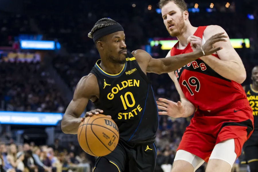 Mar 20, 2025; San Francisco, California, USA; Golden State Warriors forward Jimmy Butler III (10) drives past Toronto Raptors center Jakob Poeltl (19) during the second quarter at Chase Center. Mandatory Credit: John Hefti-Imagn Images