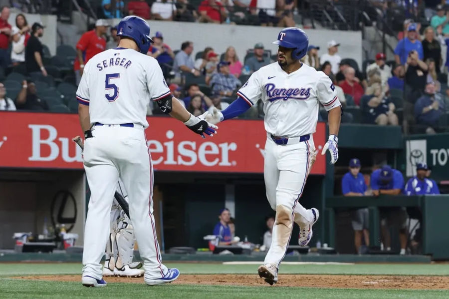 Jul 25, 2024; Arlington, Texas, USA; Texas Rangers second base Marcus Semien (2) celebrates with shortstop Corey Seager (5) after hitting a home run against the Chicago White Sox in the third inning at Globe Life Field. Mandatory Credit: Tim Heitman-Imagn Images