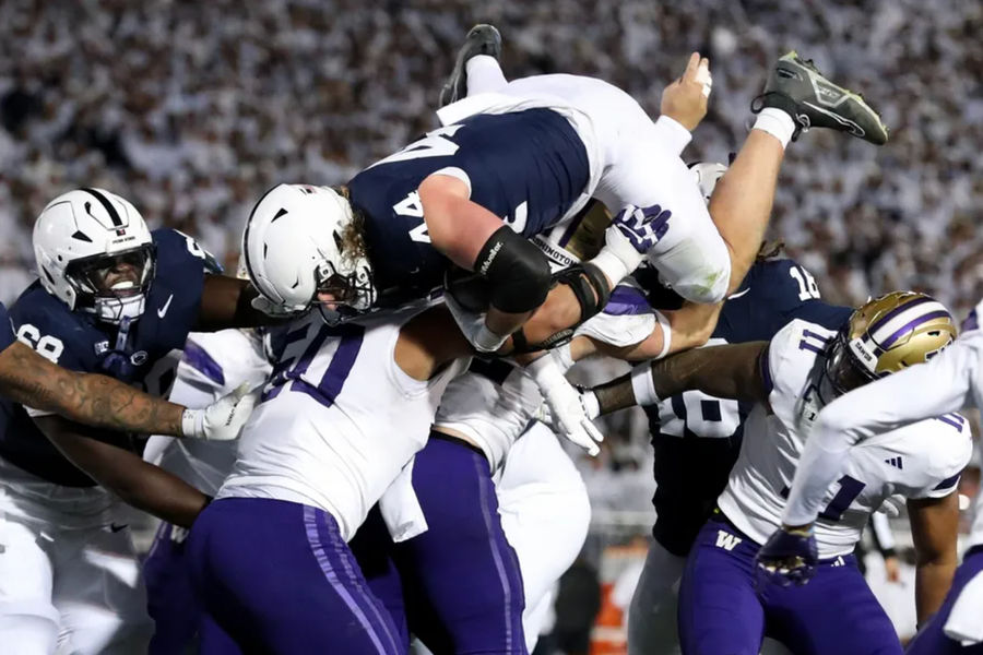 Nov 9, 2024; University Park, Pennsylvania, USA; Penn State Nittany Lions tight end Tyler Warren (44) jumps over top of the Washington Huskies defense and into the end zone for a touchdown during the second quarter at Beaver Stadium. Mandatory Credit: Matthew O'Haren-Imagn Images