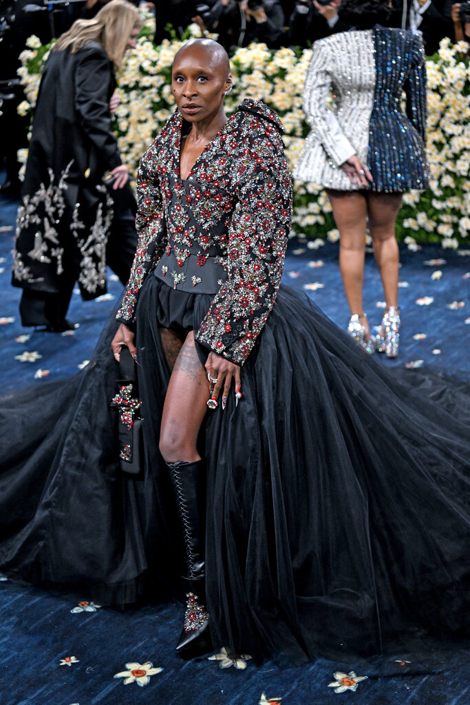 Cynthia Erivo wearing a dramatic, jeweled jacket with large shoulders and long, black tulle skirt.
