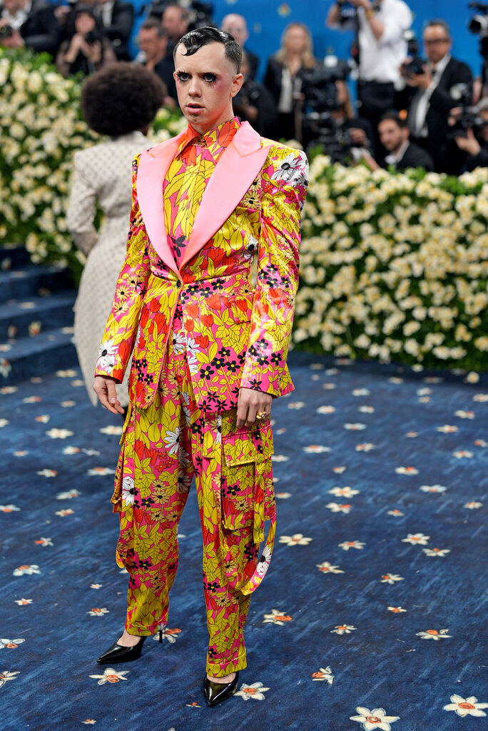 Cole Escola is wearing a brightly patterned suit.