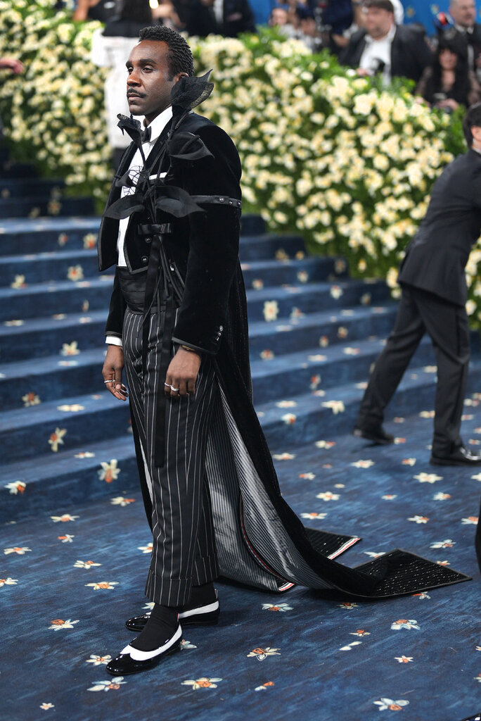 Tramell Tillman is wearing a suit adorned with flowers.