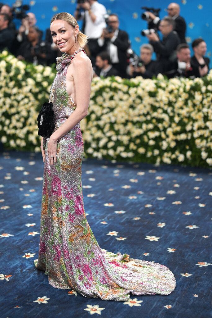 Cristina Baxter wearing a sequined halter-neck gown with floral embellishments.