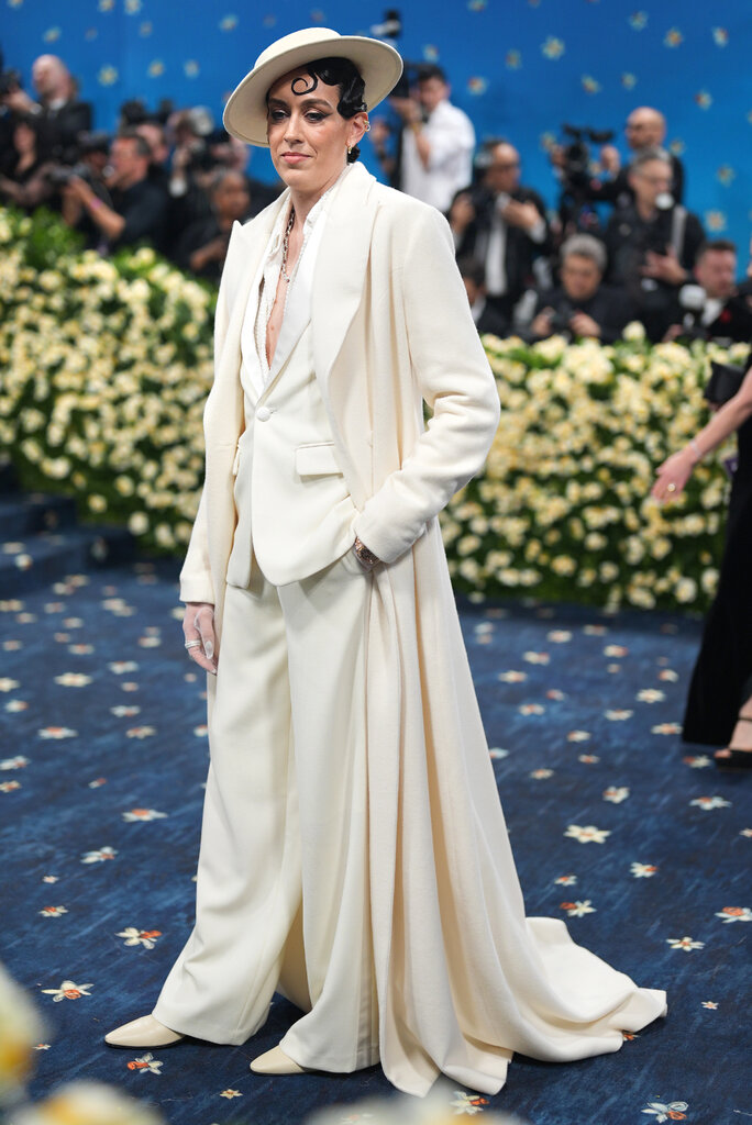 Breanna Stewart wearing a cream suit and wide-brim hat.