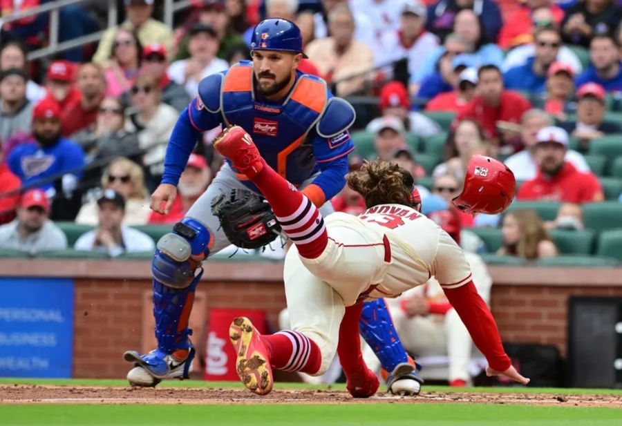 May 4, 2025; St. Louis, Missouri, USA; St. Louis Cardinals second baseman Brendan Donovan (33) dives safely to home plate in the third inning as New York Mets catcher Luis Torrens (13) waits on the throw at Busch Stadium. Mandatory Credit: Tim Vizer-Imagn Images