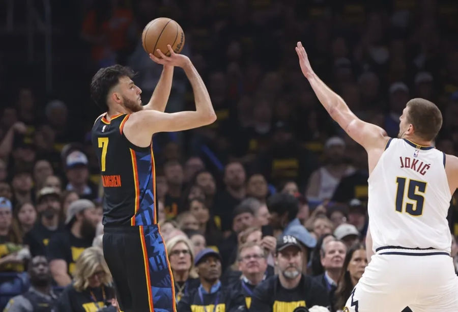 May 7, 2025; Oklahoma City, Oklahoma, USA; Oklahoma City Thunder forward Chet Holmgren (7) shoots a three point basket as Denver Nuggets center Nikola Jokic (15) defends in the first quarter during game two of the second round for the 2025 NBA Playoffs at Paycom Center. Mandatory Credit: Alonzo Adams-Imagn Images