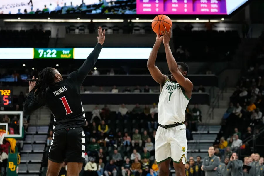 Jan 7, 2025; Waco, Texas, USA; Baylor Bears guard VJ Edgecombe (7) scores a three-point basket against Cincinnati Bearcats guard Day Day Thomas (1) during the first half at Paul and Alejandra Foster Pavilion. Mandatory Credit: Chris Jones-Imagn Images
