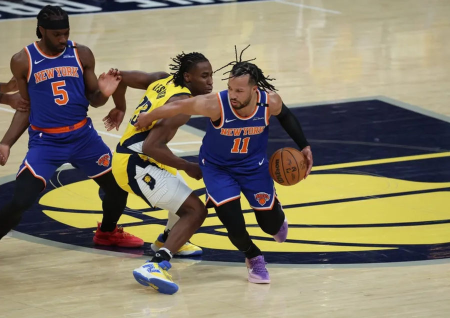 May 27, 2025; Indianapolis, Indiana, USA; New York Knicks guard Jalen Brunson (11) drives to the hoop past Indiana Pacers forward Aaron Nesmith (23) during the first quarter of game four of the eastern conference finals for the 2025 NBA Playoffs at Gainbridge Fieldhouse. Mandatory Credit: Trevor Ruszkowski-Imagn Images