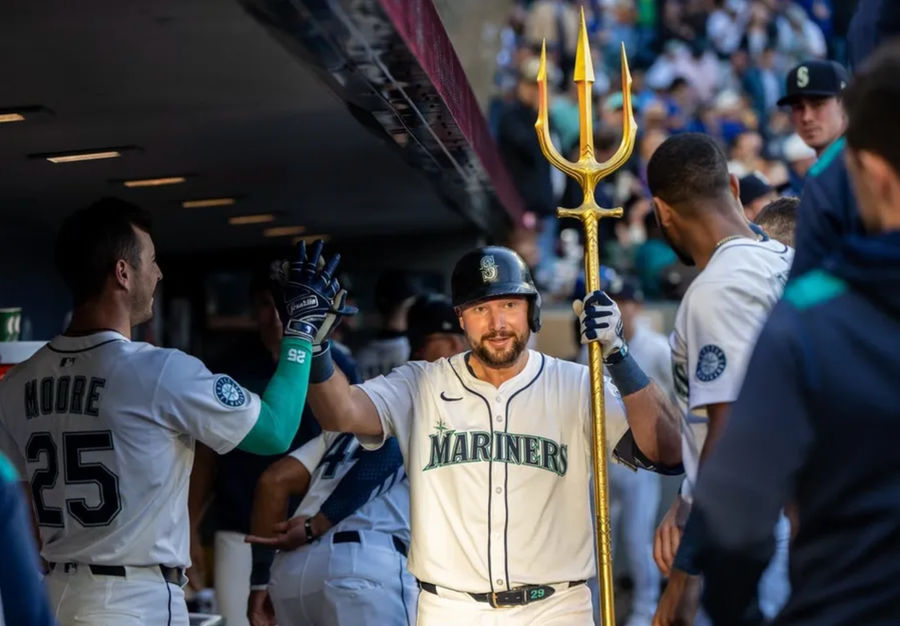 May 27, 2025; Seattle, Washington, USA; Seattle Mariners catcher Cal Raleigh (29) celebrates in the dugout after hitting a solo home run during the fifth inning against the Washington Nationals at T-Mobile Park. Mandatory Credit: Stephen Brashear-Imagn Images