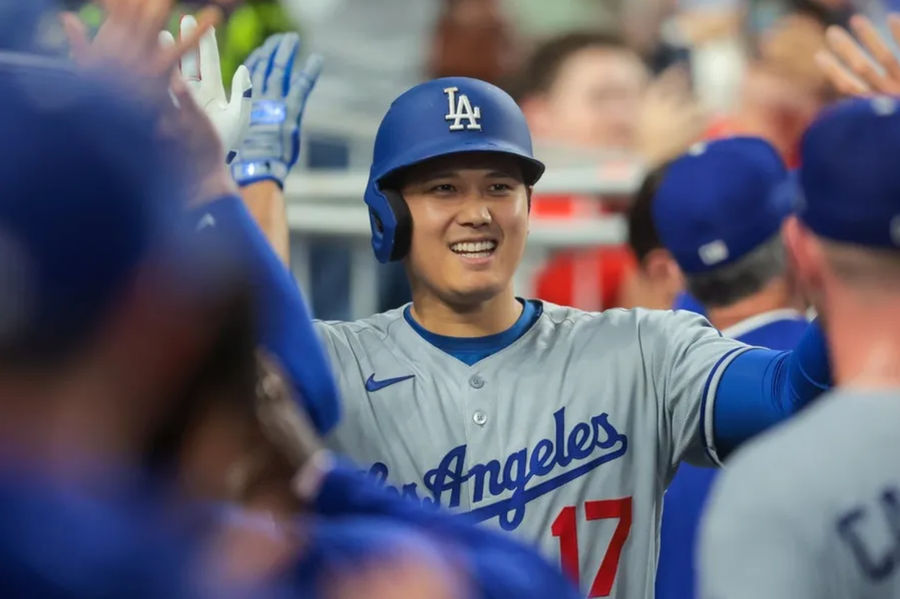 May 5, 2025; Miami, Florida, USA; Los Angeles Dodgers designated hitter Shohei Ohtani (17) celebrates with teammates after hitting a two-run home run against the Miami Marlins during the fifth inning at loanDepot Park. Mandatory Credit: Sam Navarro-Imagn Images