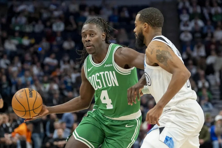 Jan 2, 2025; Minneapolis, Minnesota, USA; Boston Celtics guard Jrue Holiday (4) dribbles past Minnesota Timberwolves guard Mike Conley (10) in the first half at Target Center. Mandatory Credit: Jesse Johnson-Imagn Images