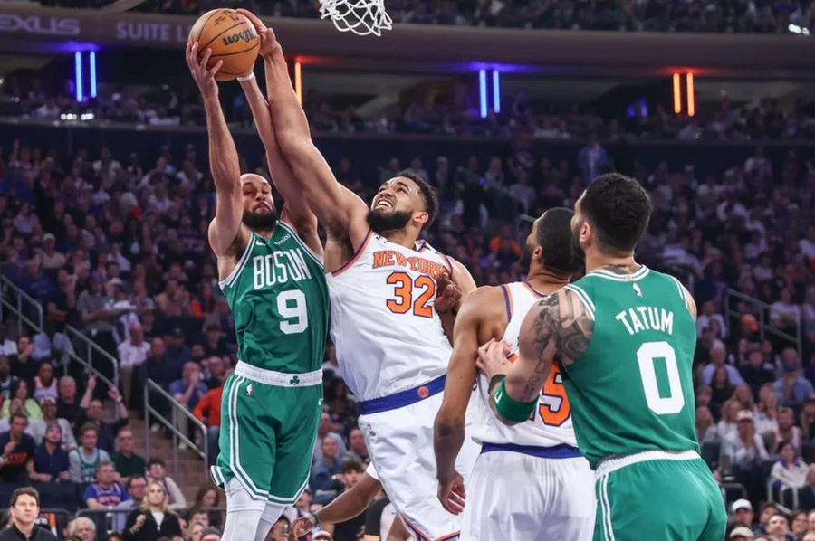 May 10, 2025; New York, New York, USA; Boston Celtics guard Derrick White (9) and New York Knicks center Karl-Anthony Towns (32) fight for a rebound in the first quarter during game three of the second round for the 2025 NBA Playoffs at Madison Square Garden. Mandatory Credit: Wendell Cruz-Imagn Images