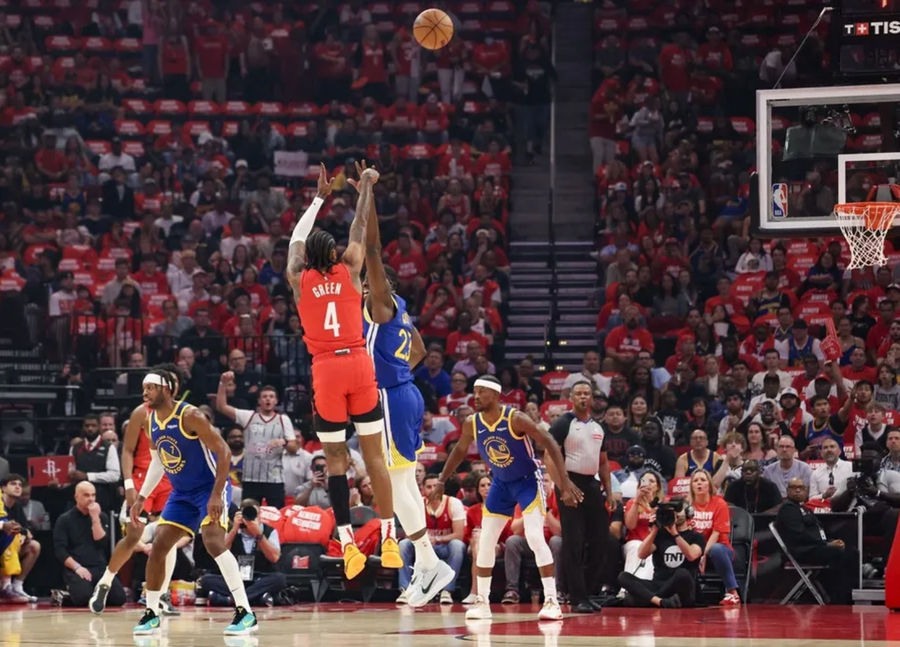 Apr 30, 2025; Houston, Texas, USA; Houston Rockets guard Jalen Green (4) makes a three point basket against Golden State Warriors forward Draymond Green (23) in the first quarter during game five of first round for the 2025 NBA Playoffs at Toyota Center. Mandatory Credit: Thomas Shea-Imagn Images