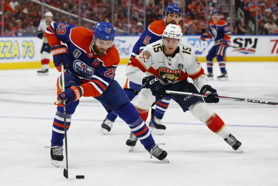 Jun 15, 2024; Edmonton, Alberta, CAN; Edmonton Oilers center Leon Draisaitl (29) skates with the puck defined by Florida Panthers center Anton Lundell (15) in the first period in game four of the 2024 Stanley Cup Final at Rogers Place. Mandatory Credit: Perry Nelson-USA TODAY Sports
