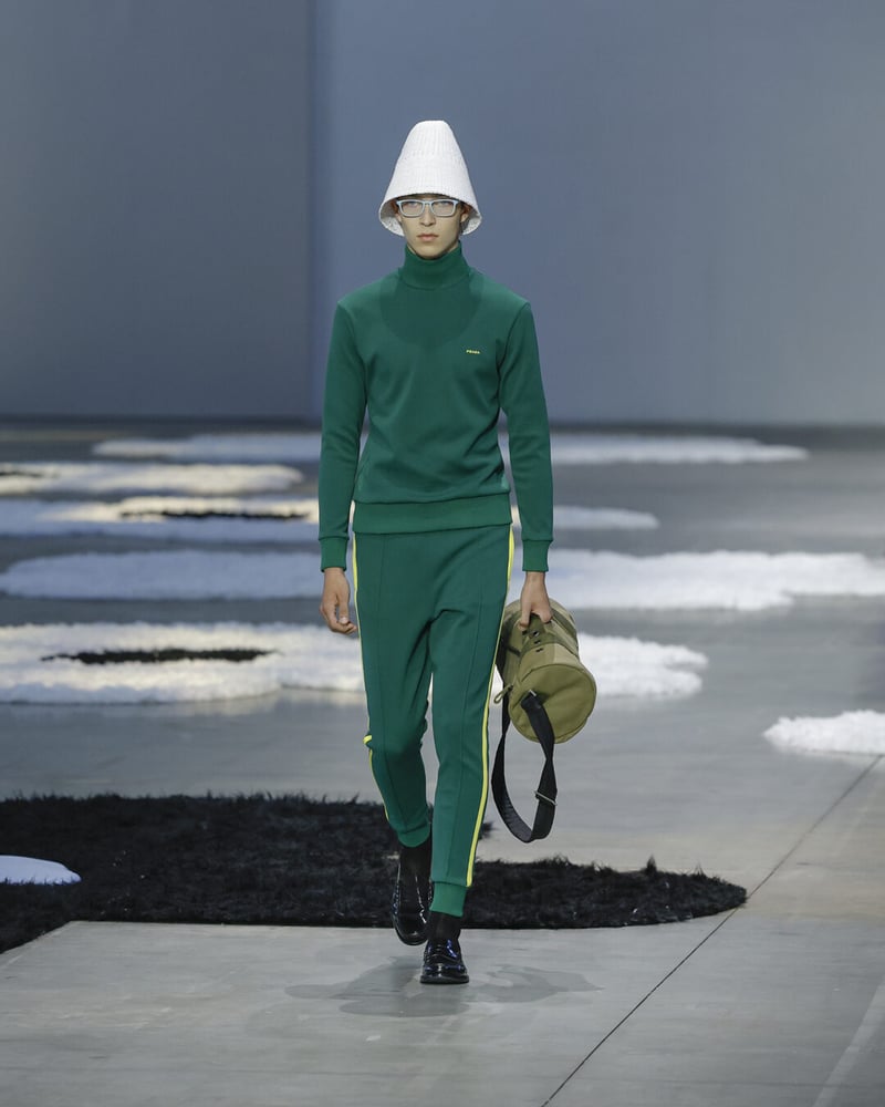 A green NATO-inspired look paired with a chunky white cloche and utilitarian gear.