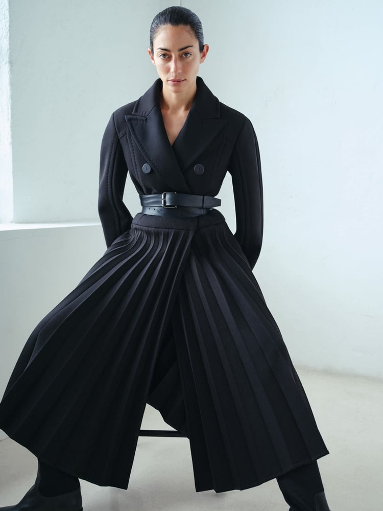 A Max Mara Atelier coat blends structure and sensuality with a pleated twist on the tuxedo silhouette for Fall/Winter 2025.