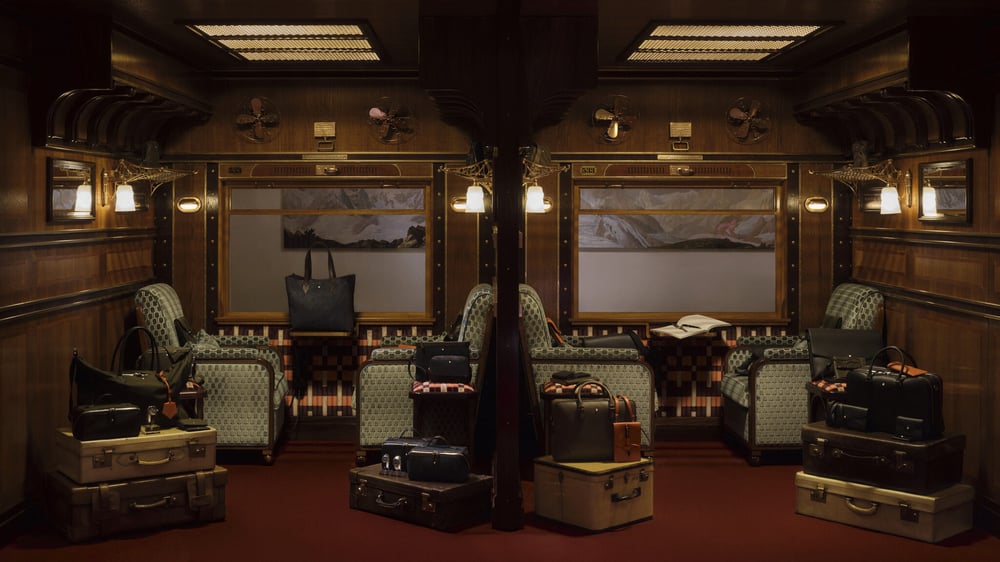 Montblanc's Spring/Summer 2026 leather goods and Art of the Desk collections, showcased in a Wes Anderson–inspired train carriage setting.