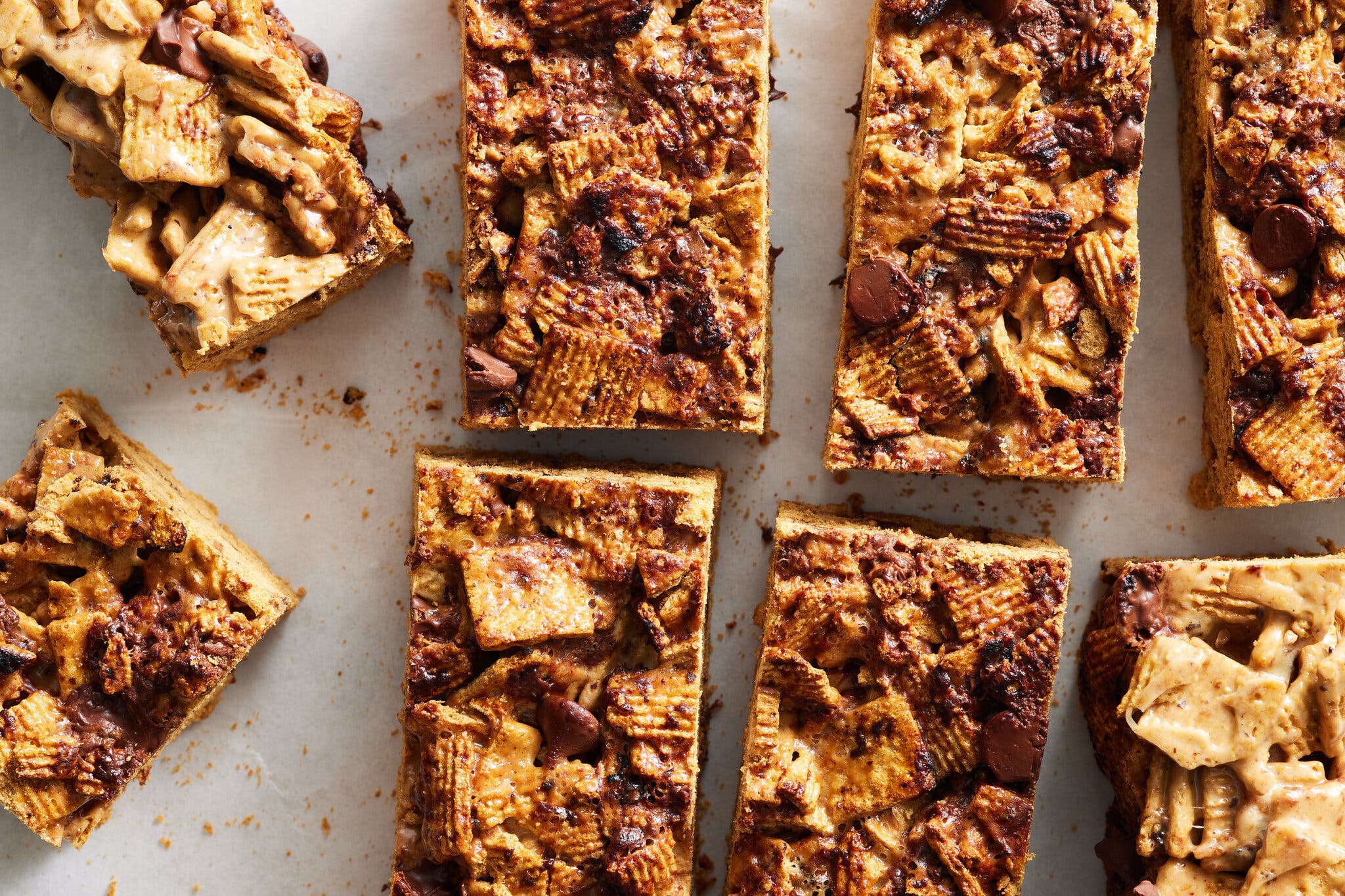 Eight cut pieces of s’mores crispy treats, photographed from above.