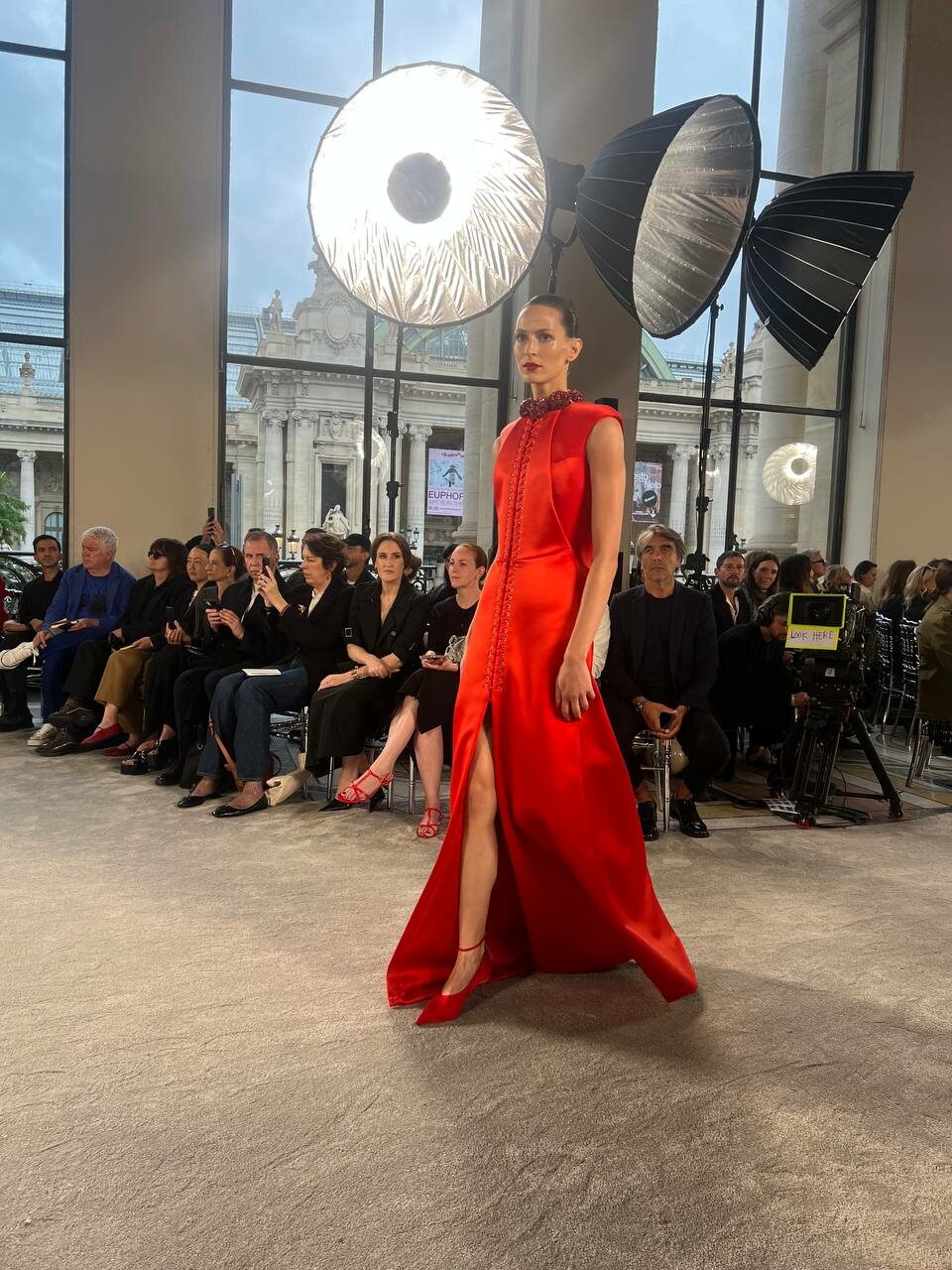 One of the few color moments: a red satin gown on the runway.