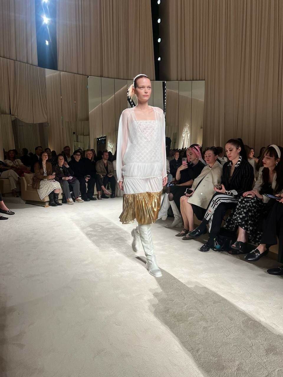 A sheer blouse paired with a metallic gold skirt nods to the collection’s playful layering and shine.