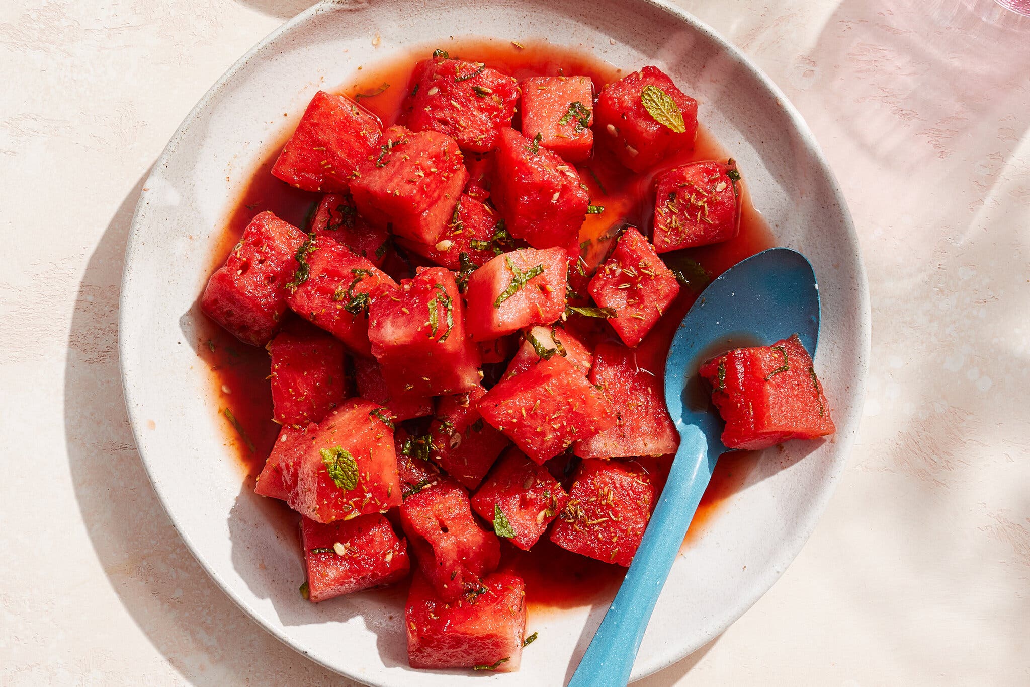 An overhead image of cubed watermelon in a bowl.