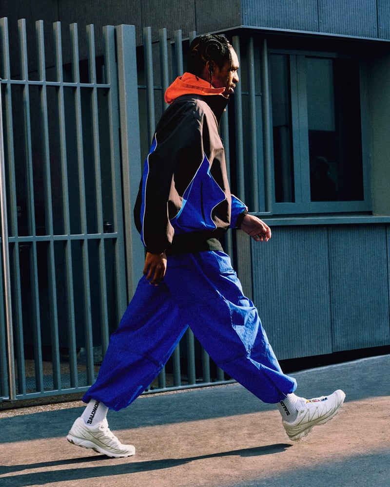 A look from Salomon’s Spring/Summer 2025 campaign featuring the XT-6 silhouette, styled with branded socks and bold urban layers.